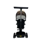 Triciclo Flex Baby Cam beige con capota, manija de empuje, asiento acolchado y canastilla, ideal para paseos seguros del bebé.