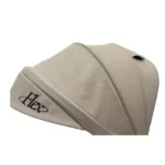 Triciclo Flex Baby Cam beige con capota, manija de empuje, asiento acolchado y canastilla, ideal para paseos seguros del bebé.