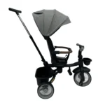 Triciclo Flex Baby Cam gris con capota, manija de empuje, asiento acolchado y canastilla, ideal para paseos seguros del bebé.