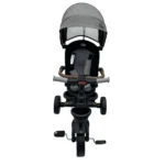 Triciclo Flex Baby Cam gris con capota, manija de empuje, asiento acolchado y canastilla, ideal para paseos seguros del bebé.