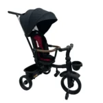 Triciclo Flex Baby Cam rojo negro con capota, manija de empuje, asiento acolchado y canastilla, ideal para paseos seguros del bebé.